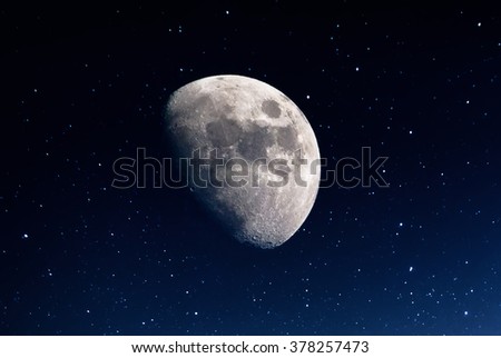 Photography of nightly sky with large moon and stars

