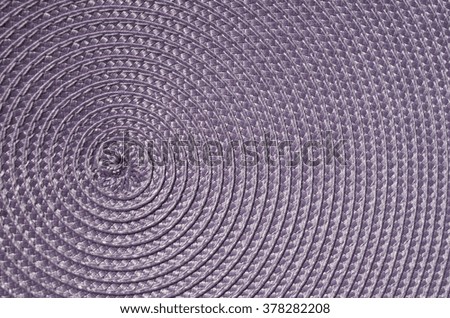 Violet rattan woven mat closeup in sunny day
