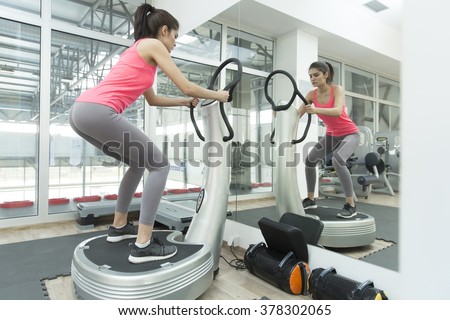 Young woman training in the gym Royalty-Free Stock Photo #378302065