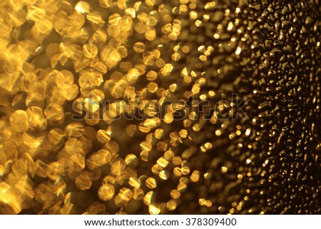 Yellow golden beautiful abstract gleam glass surface with shiny sparkling pretty golden color texture backdrop closeup, horizontal picture 