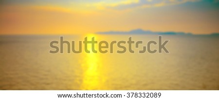 Blurred background of refraction in water. Panoramic dramatic view of Infinity sunset on the sea at twilight times.