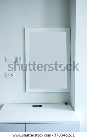 White wooden vanity table in white room