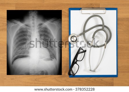 Doctor's desktop with medical equipment, computer and X-ray top view