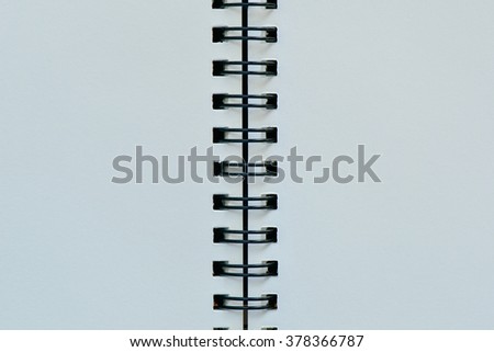 Vertical white page with black binder for background