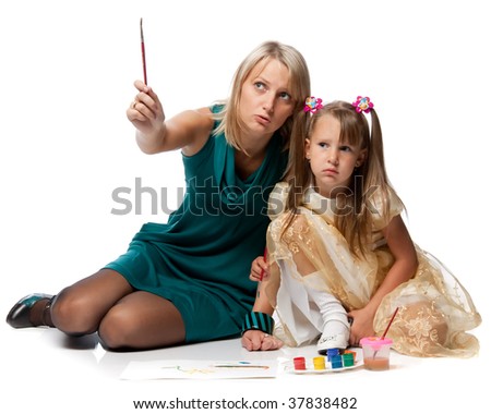 Young mum with a daughter draw a picture paints on a white background.