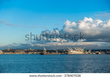 Clouds hover over the Port of Seattle skyline on a sunny spring day.