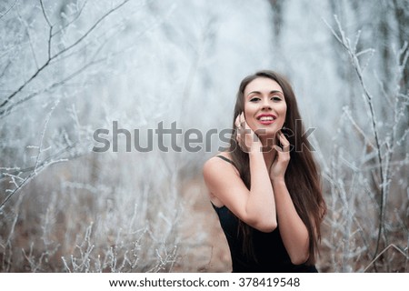 Beautiful girl in the winter forest.