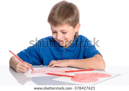 boy drawing a heart that says I love mom