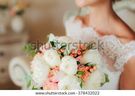 Wedding bouquet in hands of the bride Royalty-Free Stock Photo #378432022