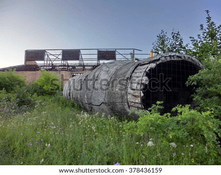 Industrial cement crumbling hollow tube - landscape color photo