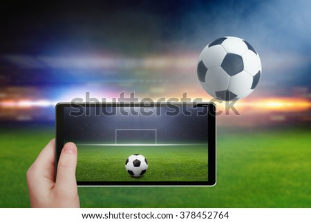 Abstract technology background - tablet pc in hand, soccer ball, stadium in night, sports game online, augmented reality concept
