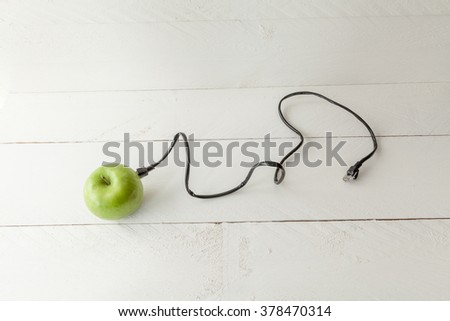 The picture shows an apple connected to an ethernet cable conceptualizing the internet of things and wearables