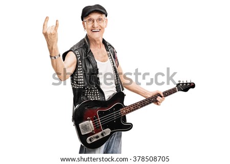 Studio shot of an old punk rocker holding a bass guitar and making a rock gesture isolated on white background