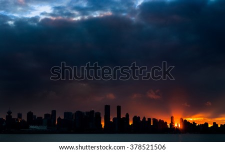 Silhouette of the Downtown Vancouver skyline at sunset. 