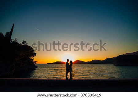 Silhouettes at sunset on the beach