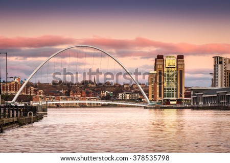 Millennium Bridge at sunset / The Iconic Millennium Bridge crosses the River Tyne joining the Quaysides of Newcastle and Gateshead for cycles and pedestrians Royalty-Free Stock Photo #378535798