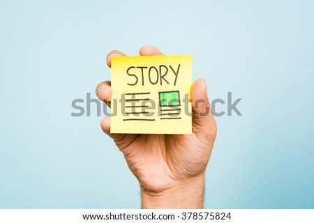 Storyteller content story title marketing photography concept. One hand showing a yellow note with a big title "story" on blue background. Useful for digital marketing or inboud marketing.