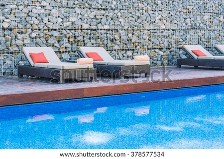 Umbrella pool and chair in beautiful luxury hotel pool resort - Filter Processing style pictures