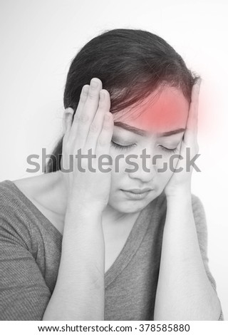 Close up of woman having headache black and white tone.Concept photo with Color Enhanced blue skin with read spot indicating location of the pain; Healthcare Concept ;Medical Concept 