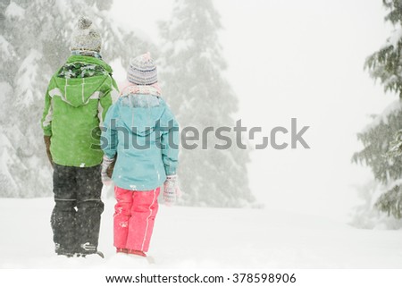 Children standing in the snow