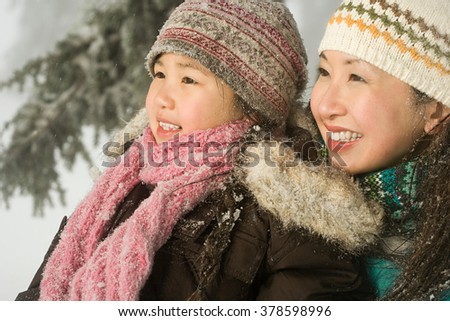 Mother and daughter in snow