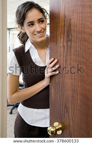 Young woman by door