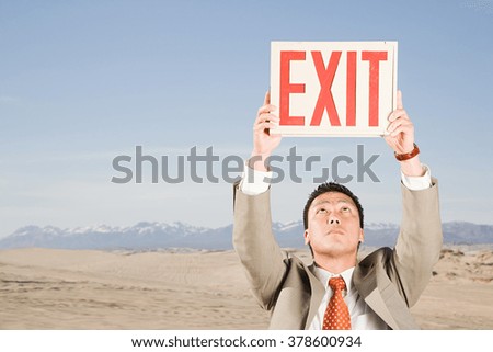 Man in desert with exit sign