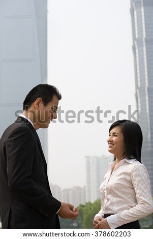 Two business colleagues near skyscrapers