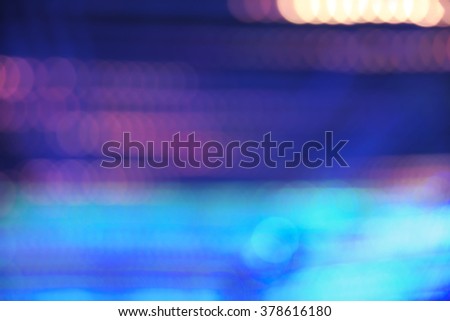Abstract vibrant blue, violet, and orange bokeh over dark background