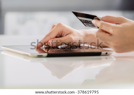 Woman shopping using tablet pc and credit card Royalty-Free Stock Photo #378619795