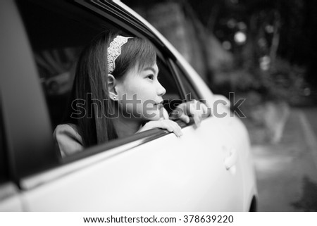 oung woman in her new car smiling.