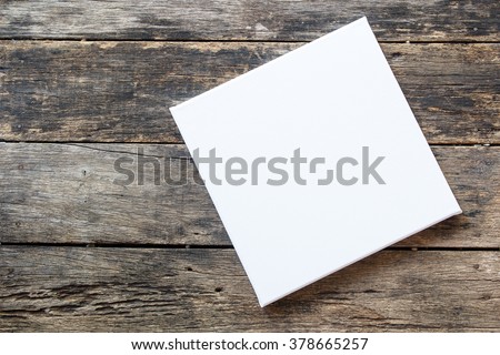 White canvas frame on a wooden background