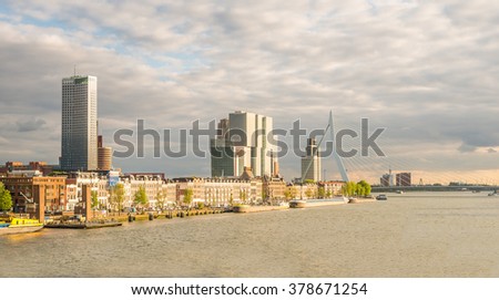 Rotterdam City, Erasmus Bridge, Container Ship (Cargo Ship) of harbor cruise Rotte river and Aerial View Cityscape Panorama Skyline under Dramatic Golden Sky Sunset Summer, Netherlands