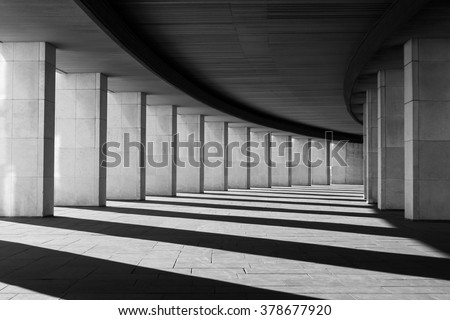 Long tunnel with columns in black and white Royalty-Free Stock Photo #378677920