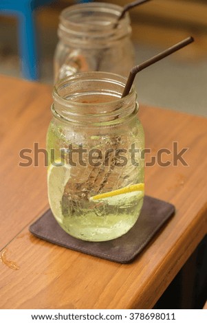 Fresh cocktail with soda, Hot Summer color style, lime on a wooden background