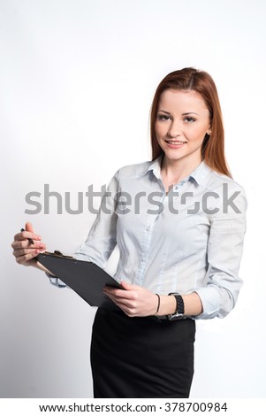 Young pretty business woman with tablet paper isolated on grey background