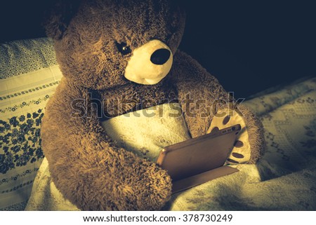Teddy bear use tablet in bed, effect by vintage style