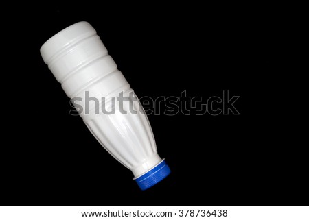 milk plastic bottle isolated on black background