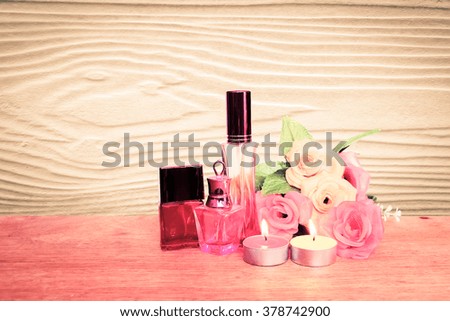 cosmetic container and candle with wooden background