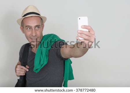 Tourist man taking picture with mobile phone
