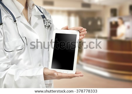 blurred background of clinic and free space on tablet for you 