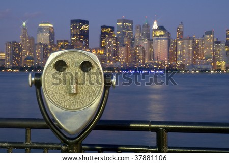steel binoculars in jersey city, New York's Manhattan in background, dusk photo