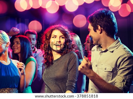 party, holidays, celebration, nightlife and people concept - smiling friends dancing in club Royalty-Free Stock Photo #378851818