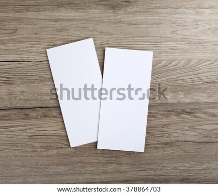 Blank flyer over wooden background to replace your design Royalty-Free Stock Photo #378864703