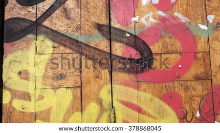 Texture background. Old wall with graffiti. Abstract street pattern paint. Old wooden wall painted paint