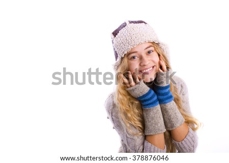 beautiful young blond woman in a hat on a white background in studio