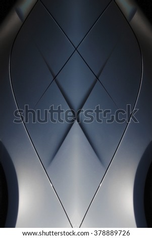 Close-up of metal object with rhombic pattern resembling hi-tech mannequin's chest and neck dressed in shirt, tie and jacket. Abstract background composition on the subject of technology or fashion.