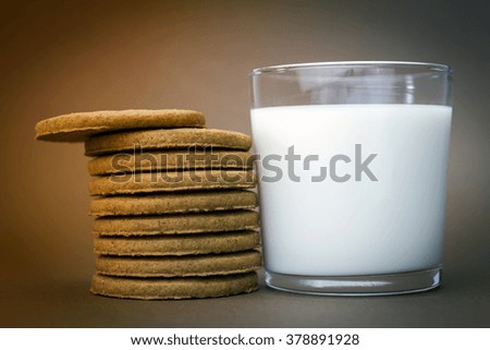 Glass of milk and biscuits round