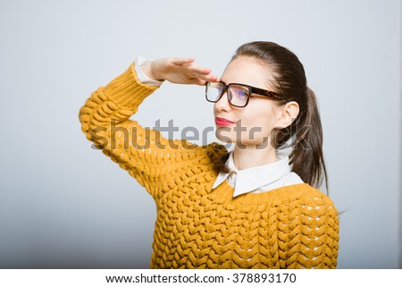 hipster girl looks into the future, with glasses isolated on a gray background
