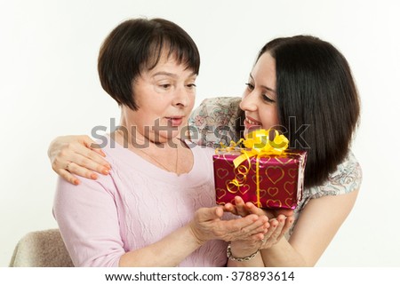 the woman gives to mother a gift